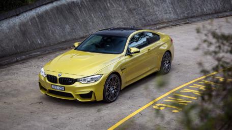 Sleek Yellow BMW M4 on Urban Street Scene wallpaper