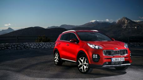 Stylish Red SUV in Scenic Landscape wallpaper