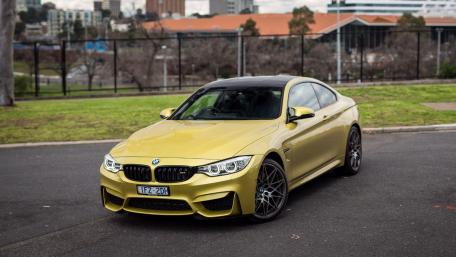 Sleek Yellow BMW Coupe on Display wallpaper