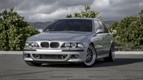 Sleek Silver BMW Standing Proudly on the Road wallpaper