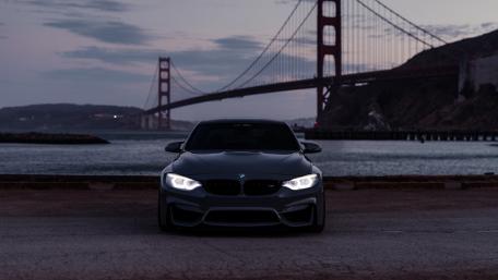 Sleek BMW Under Golden Gate Bridge at Dusk wallpaper