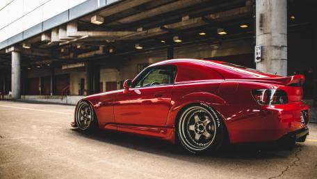 Sleek Red Sports Car in Urban Setting wallpaper