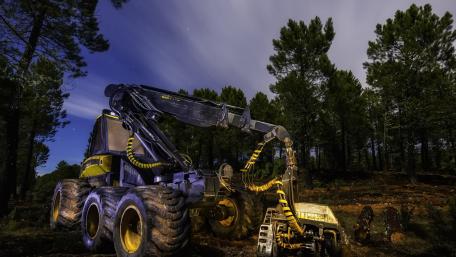 Heavy Machinery Under Starry Night Sky in Forest wallpaper