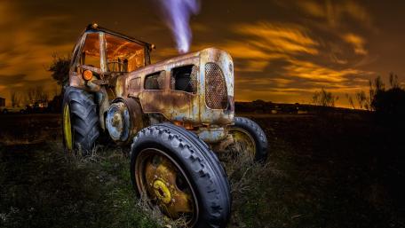 Rusty Tractor Under Starry Sky wallpaper