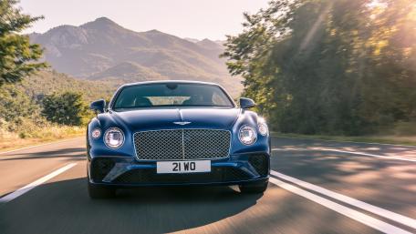 Sleek Blue Bentley on a Scenic Roadway wallpaper
