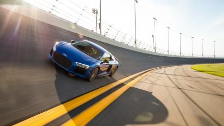 Sleek Blue Sports Car in Motion wallpaper