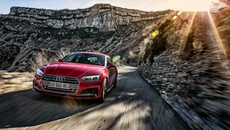 Dynamic Audi Driving Through Scenic Landscape wallpaper