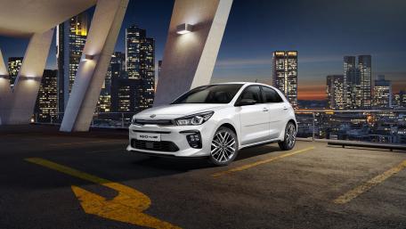 Sleek Urban Car in Vibrant Cityscape wallpaper