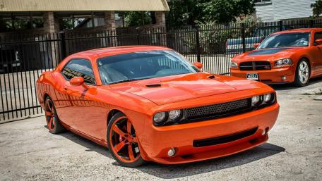Vibrant Orange Muscle Cars Showcased Together wallpaper