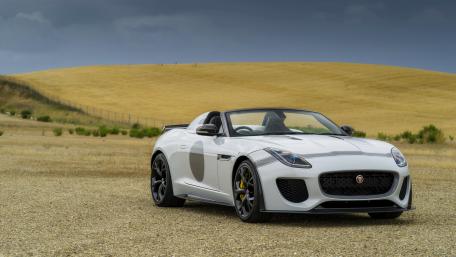 Sleek White Sports Car Under Dramatic Sky wallpaper