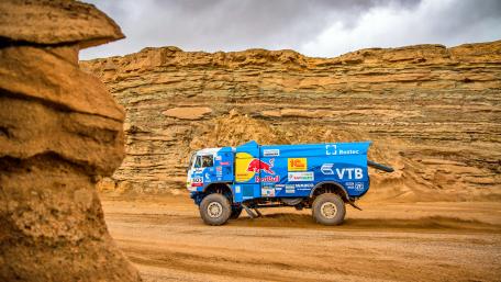 Powerful Rally Truck Racing Through Rugged Terrain wallpaper