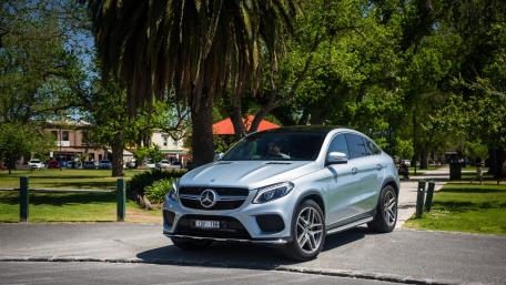 Sleek Silver SUV in a Lush Green Setting wallpaper
