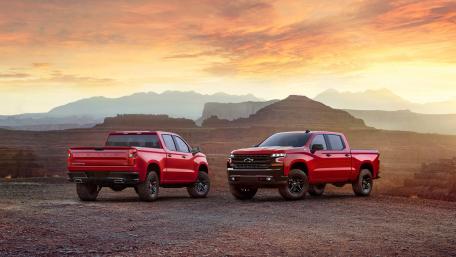 Bold Red Trucks Against a Majestic Sunset Landscape wallpaper