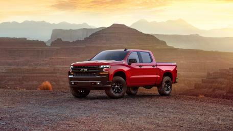 Bold Red Truck Against Majestic Landscape Sunrise View wallpaper
