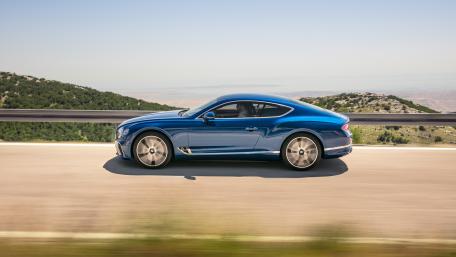 Sleek Blue Luxury Car on Open Road wallpaper