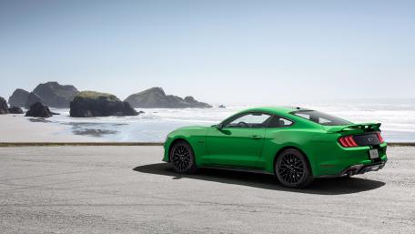 Vibrant Green Mustang by the Ocean Shoreline wallpaper