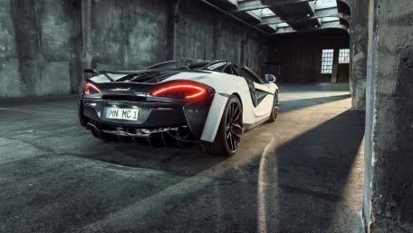 Sleek McLaren in an Abandoned Warehouse Environment wallpaper