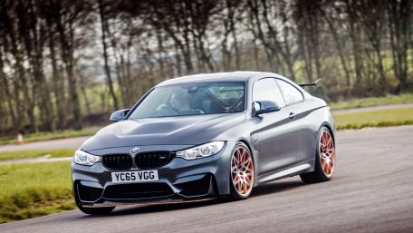 Sleek BMW M4 Racing on a Curvy Track wallpaper
