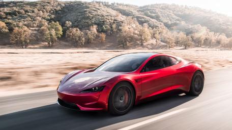 Sleek Red Electric Car on Open Road wallpaper