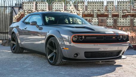 Sleek Muscle Car on Display in Urban Setting wallpaper