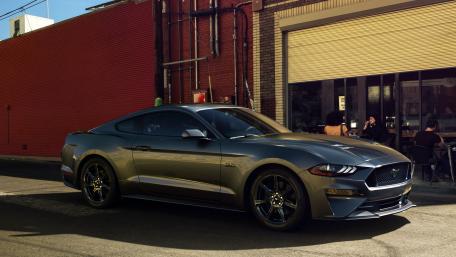 Sleek Modern Muscle Car in Urban Setting wallpaper