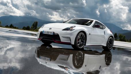 Sleek White Sports Car in Dynamic Atmosphere wallpaper