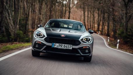 Sleek Sports Car on a Scenic Roadway wallpaper