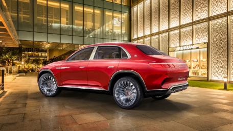 Sleek Red Luxury SUV in Urban Landscape wallpaper
