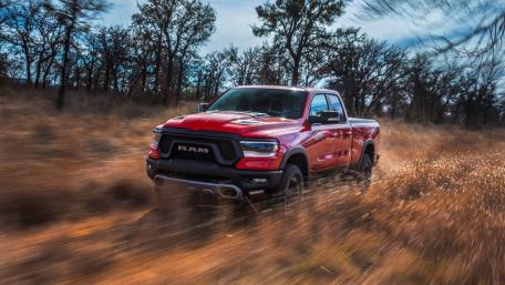 Rugged Red Truck in Motion Along the Trail wallpaper