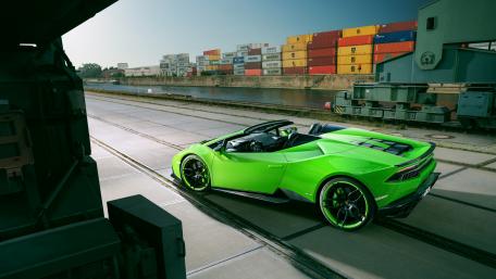 Vibrant Green Supercar in Urban Setting wallpaper