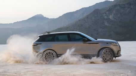 Sleek SUV Thrilling Through Sandy Terrain wallpaper