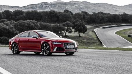 Sleek Red Audi on Scenic Track wallpaper