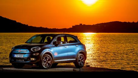 Stylish Car Against a Sunset Background wallpaper