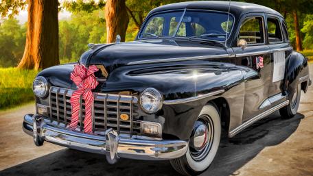 Classic Black Car Elegance with Celebratory Ribbons wallpaper