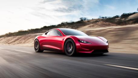 Sleek Red Sports Car in Motion wallpaper