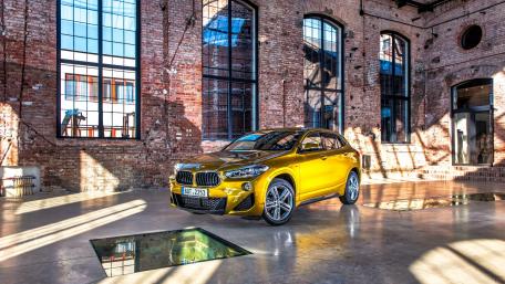 Sleek Yellow SUV in an Urban Warehouse Setting wallpaper