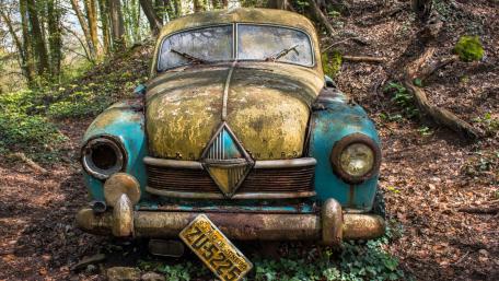 Rusty Vintage Car in a Forest Setting wallpaper