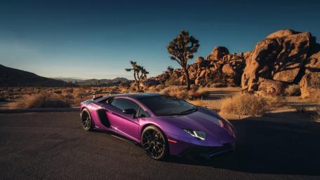 Vibrant Purple Lamborghini in Desert Landscape wallpaper