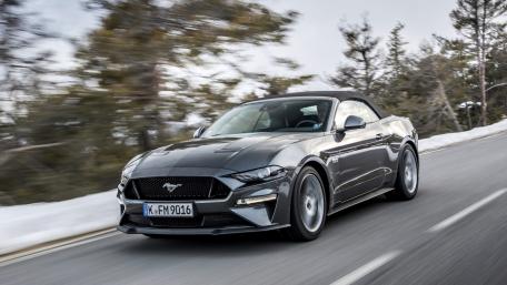 Sleek Mustang Convertible in Motion on a Snowy Road wallpaper