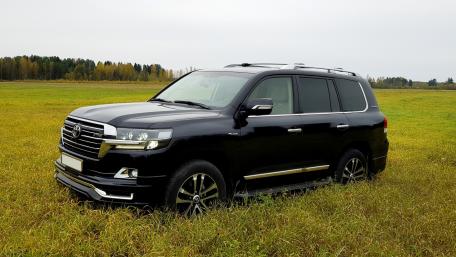 Sleek Black SUV in a Serene Landscape wallpaper