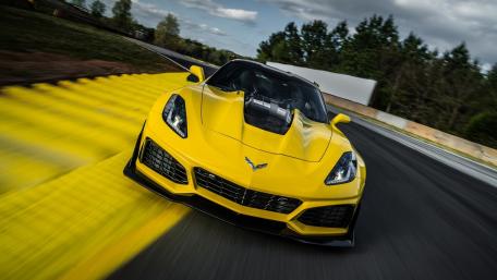 Vibrant Yellow Corvette Racer in Motion wallpaper
