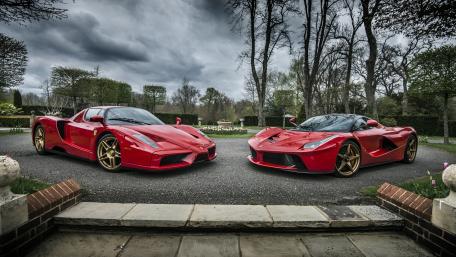 Elegant Red Supercars Under Dramatic Skies wallpaper