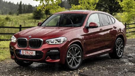 Sleek Red BMW on a Rainy Day wallpaper