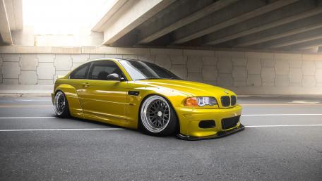 Vibrant Yellow Car Under Urban Overpass wallpaper