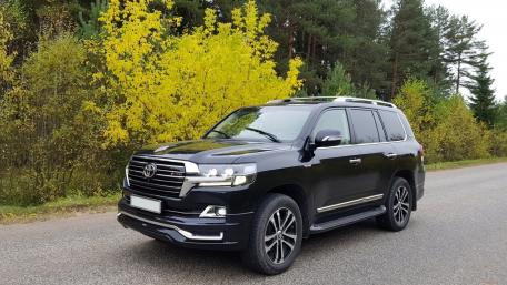 Sleek Black SUV on Autumn Road wallpaper