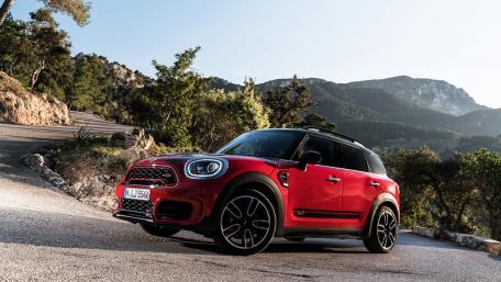 Vibrant Red Car in Scenic Landscape wallpaper