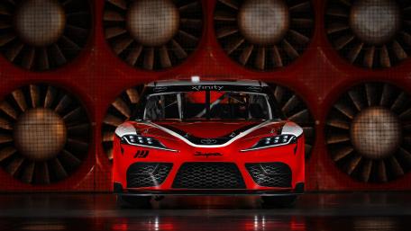 Dynamic Red Racing Car Wallpaper for Enthusiasts wallpaper