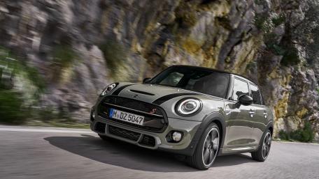 Sleek Mini Cooper on Scenic Roadway wallpaper