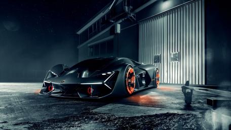 Sleek Black Sports Car Under Industrial Lights wallpaper
