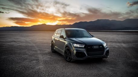 Sleek Audi SUV Against Stunning Sunset Background wallpaper